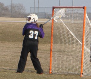 Julie blocks the shot and clears it out to another team member.