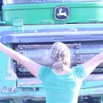 Junior Leah Petersen stands in front of a 2007 John Deere 9760. The tractor was driven to school as a part of the "hick" tradition, where FFA and similar AG students drive their field tractors to school.