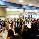 Students of all grades in the lunch room gather to sign year books.