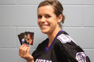 Senior Section Editor Sophie Jundt holds the three most recent senior photo submissions. Photo by Megan Downing