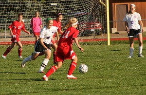 Olivia Haggerty hustles for the ball against Monticello. Photo By Rachel Etter