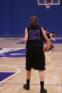 Sophmore Jamie High watches her teammate and opponent fight for the basketball Photo by Maggie O'donnell