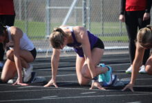 Rose Lamberts '26 at the starting blocks before a hurdles race on April 28.