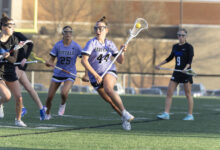 Hannah Rosso '28 carries the ball in a game on May 18. Photo by Braxton Teschendorf