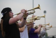 Lilah Dongoski plays the trumpet during a marching band rehearsal on May 9.