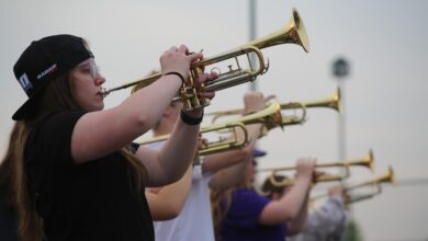 Lilah Dongoski plays the trumpet during a marching band rehearsal on May 9.
