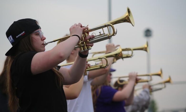 Lilah Dongoski plays the trumpet during a marching band rehearsal on May 9.
