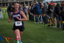 Cady Macheel smiling as she sees the clock at the finish line.