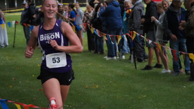 Cady Macheel smiling as she sees the clock at the finish line.