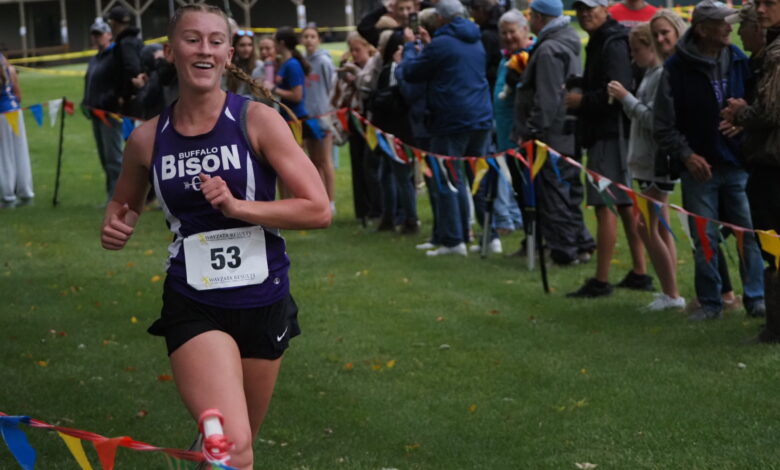 Cady Macheel smiling as she sees the clock at the finish line.