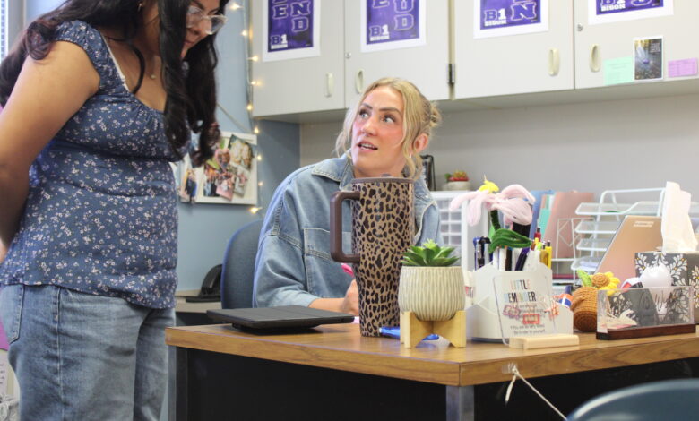 Math Teacher Reese Wishart checks in with a student during class