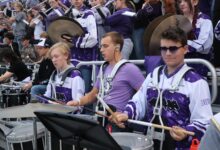 The pep band plays together in the stands during the Homecoming football game