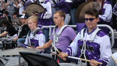 The pep band plays together in the stands during the Homecoming football game
