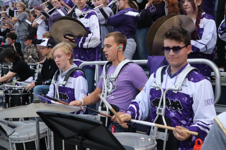 The pep band plays together in the stands during the Homecoming football game
