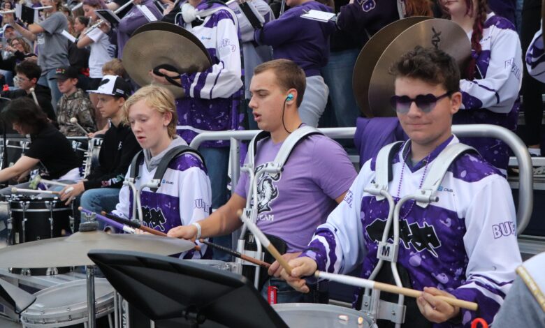 The pep band plays together in the stands during the Homecoming football game
