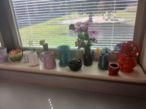Vases created in Mrs. Post's art class sit on display