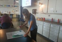 Art teacher Jillian Post paints on a canvas