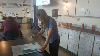 Art teacher Jillian Post paints on a canvas