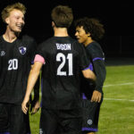 Stone Hoel '27 celebrates with teammates after scoring a hat trick against Alexandria on October 5.