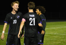 Stone Hoel '27 celebrates with teammates after scoring a hat trick against Alexandria on October 5.