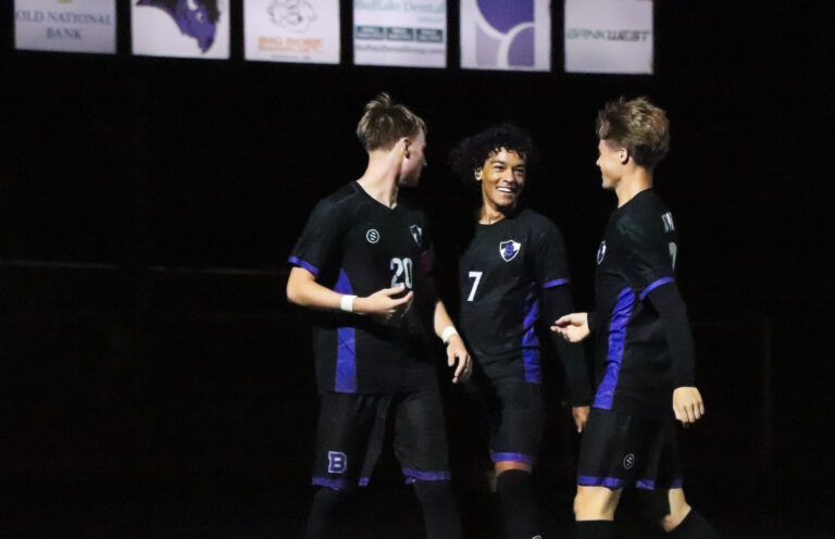 Boys Soccer players celebrate after a goal against Rogers on September 29.
