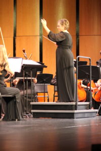 Kristine Weise conducts the orchestra during a concert on October 22. 