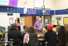 A teacher is presenting to students.