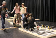 Members of the Tech Crew begin assembling the set for Grease.