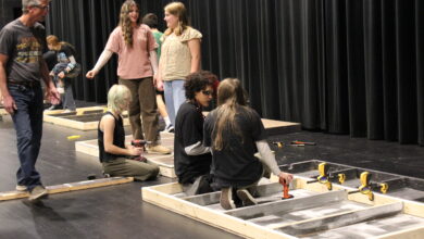 Members of the Tech Crew begin assembling the set for Grease.