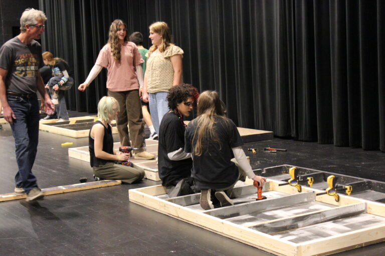 Members of the Tech Crew begin assembling the set for Grease.
