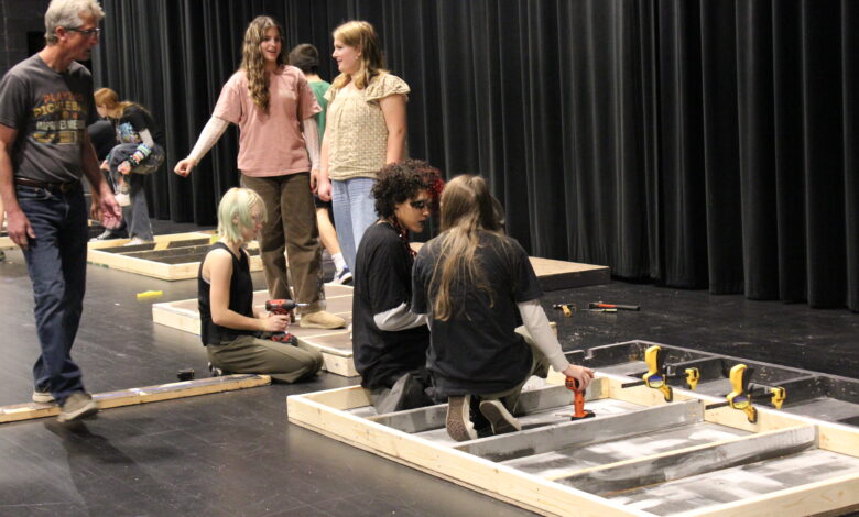 Members of the Tech Crew begin assembling the set for Grease.
