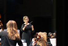 Orchestra teacher Kristine Weise conducts at the first orchestra concert of the year