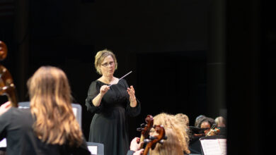 Orchestra teacher Kristine Weise conducts at the first orchestra concert of the year