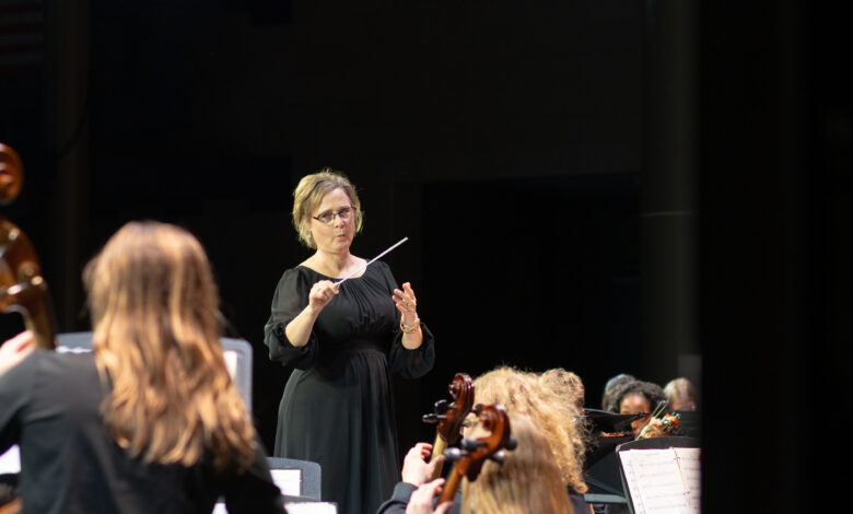 Orchestra teacher Kristine Weise conducts at the first orchestra concert of the year