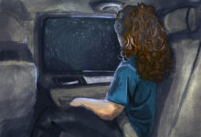 A girl wearing headphones looks out a car window form the back seat during a nighttime drive.