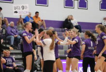 Sophomores on the Varsity Volleyball Team celebrate on the sidelines.