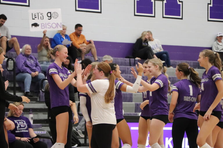 Sophomores on the Varsity Volleyball Team celebrate on the sidelines.