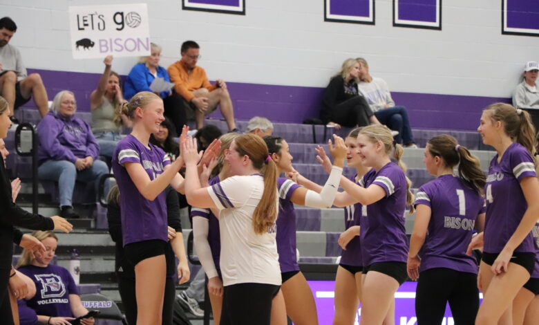 Sophomores on the Varsity Volleyball Team celebrate on the sidelines.