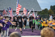 BHS boys football running on the field to begin the game