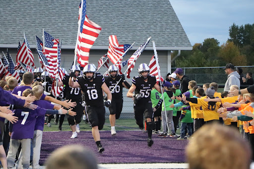 BHS boys football running on the field to begin the game